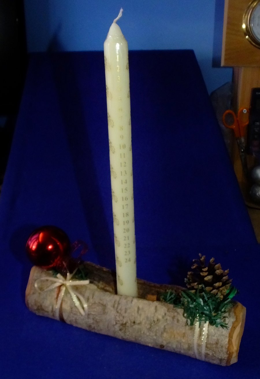 Advent candle in a driftwood holder for the festive season at Christmas