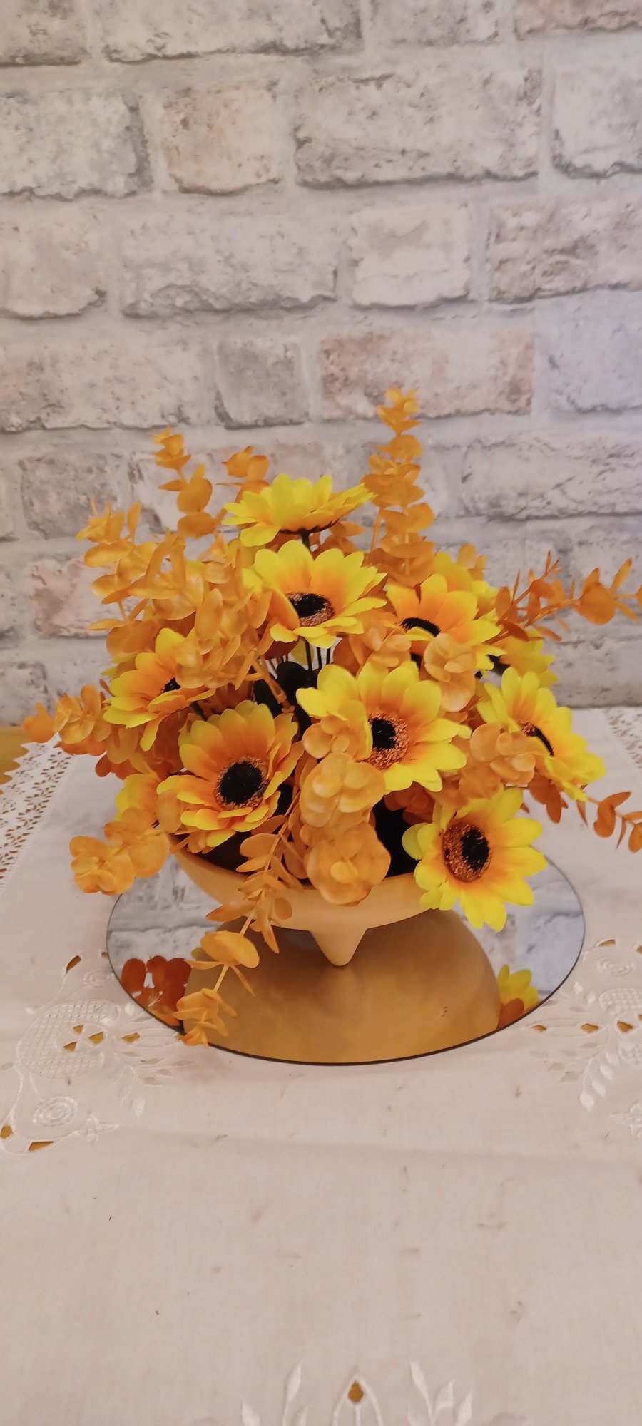 terracotta dish with orange and yellow  faux sunflowers
