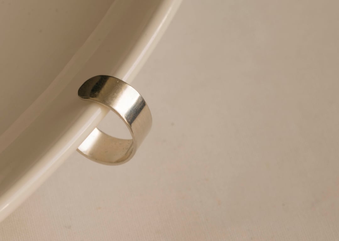 Slim silver ear cuff with a highly polished mirror finish