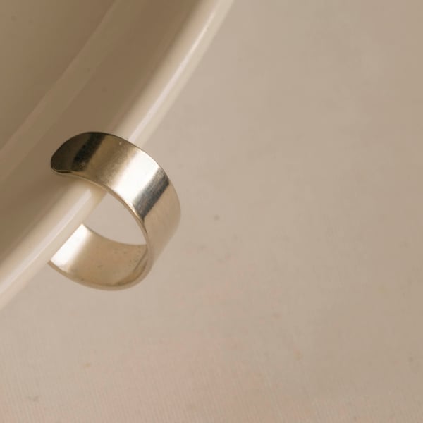 Slim silver ear cuff with a highly polished mirror finish