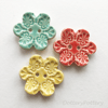 Set of three flower shaped ceramic handmade buttons