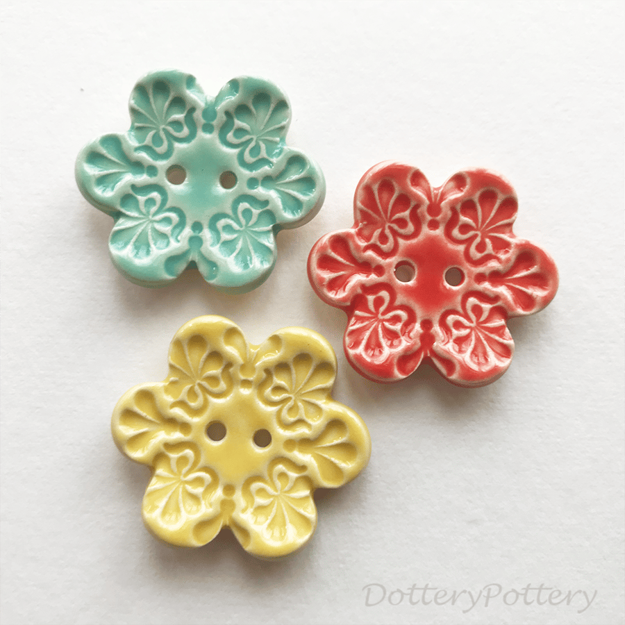 Set of three flower shaped ceramic handmade buttons