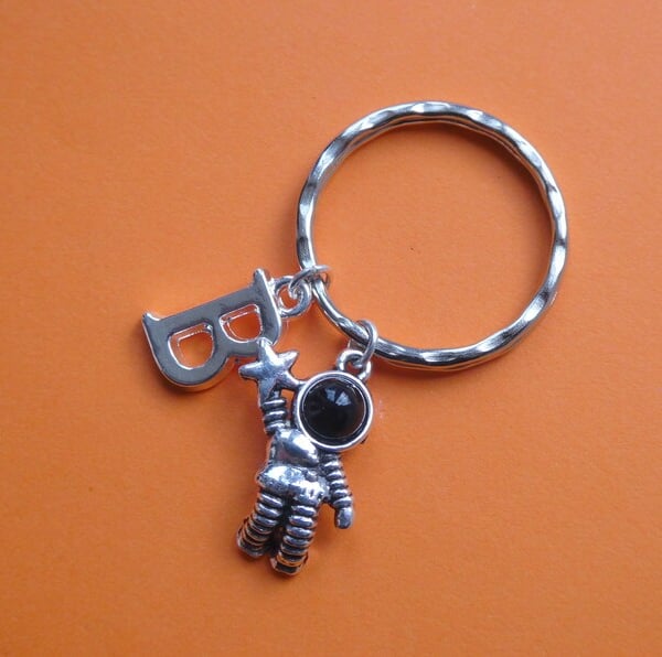 Silver astronaut keychain with initial