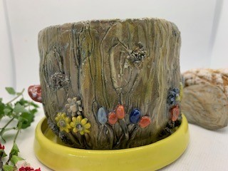 Plant pot decorated with flowers and funghi