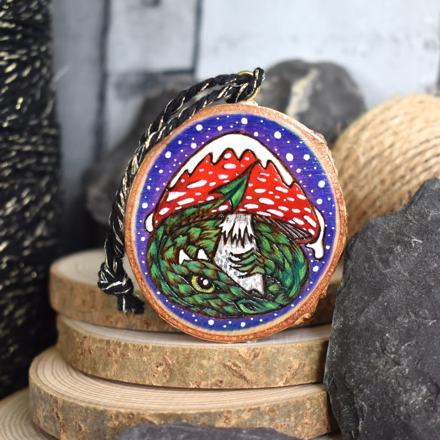 Dragon under a snowy toadstool pyrography hanging wood slice decoration