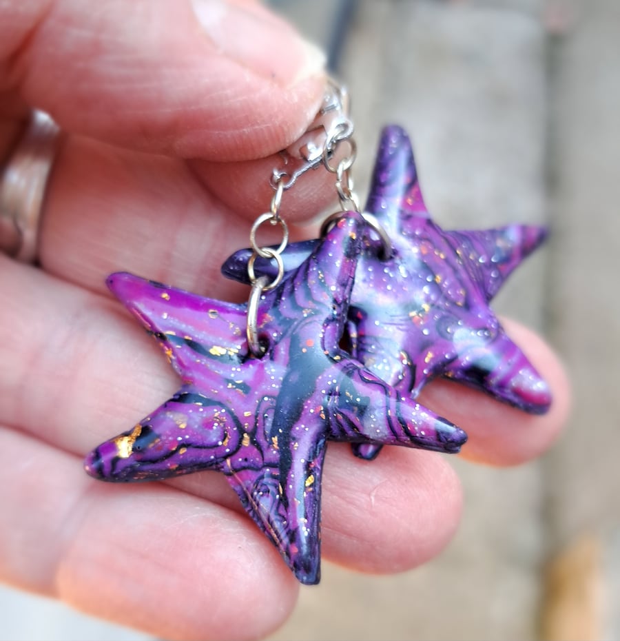 Funky pair of bright purple, black and gold leaf star earrings