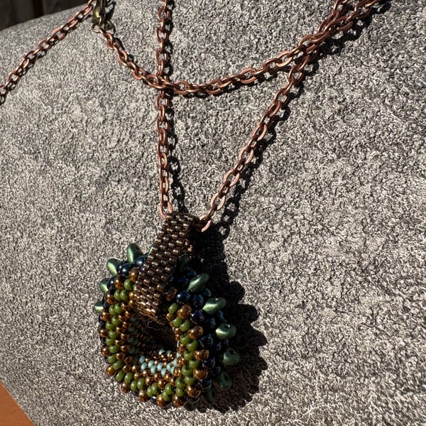 Spiky beaded donut pendant