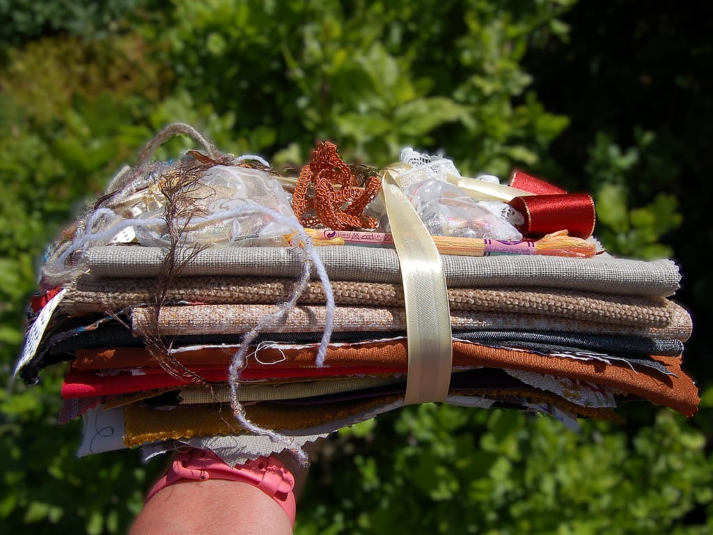 Upcycled slow stitching kit includes fabric, buttons, thread, lace, ribbon