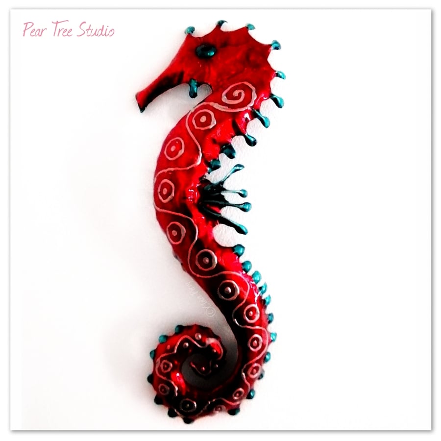 Red and Turquoise metal Seahorse wall Decoration. Made from a coffee tin.
