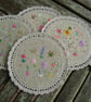 Round embroidered and reversible fabric coasters. - Image 2