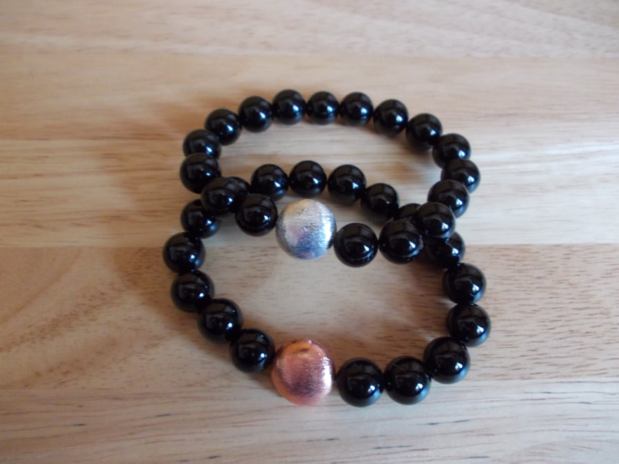 Black agate elasticated bracelets with copper coin charms