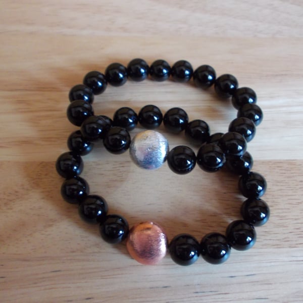 Black agate elasticated bracelets with copper coin charms