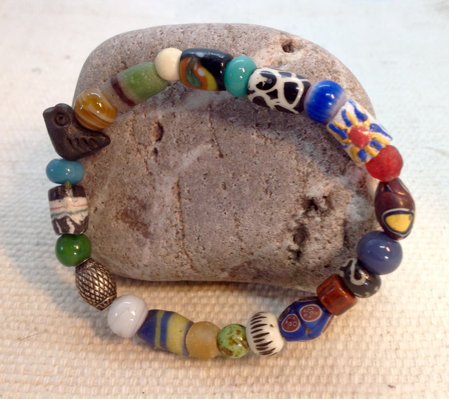 Bead collection on a bracelet with a vintage bird bead