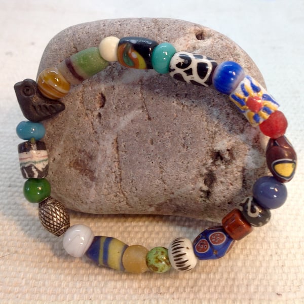 Bead collection on a bracelet with a vintage bird bead