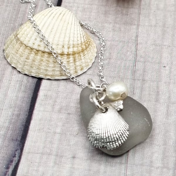 Real shells coated in silver with sea glass and bead, unique item!