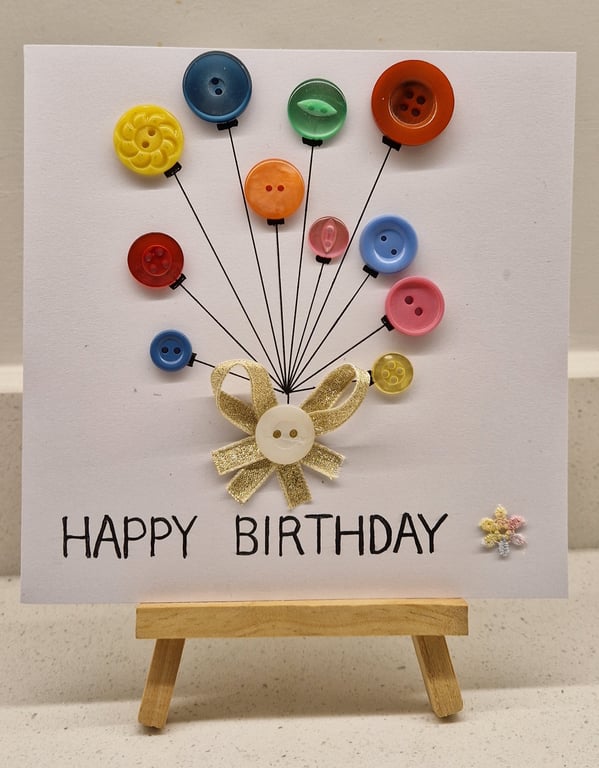 Happy birthday card of buttons as balloons tied with gold ribbon hand drawn 