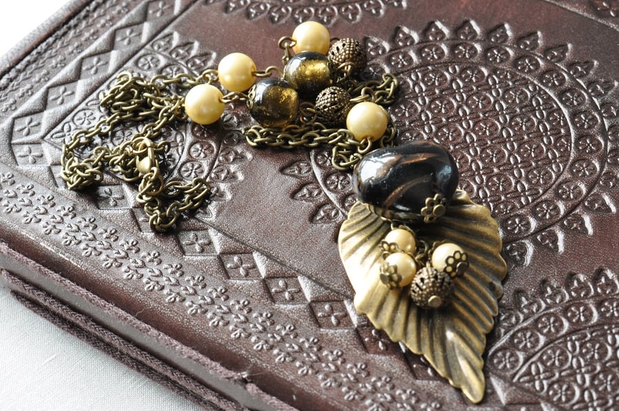 Antique Bronze Plated Leaf with Black Heart and Cream and Black Bead Necklace