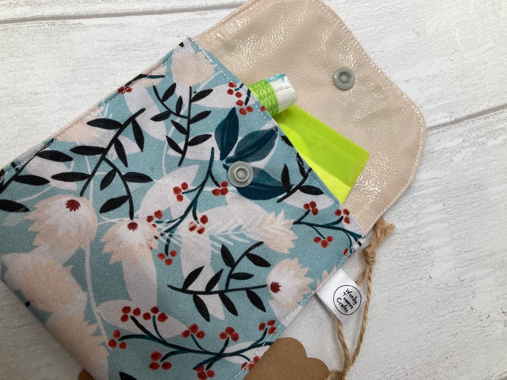 Sanitary product holder for handbag.