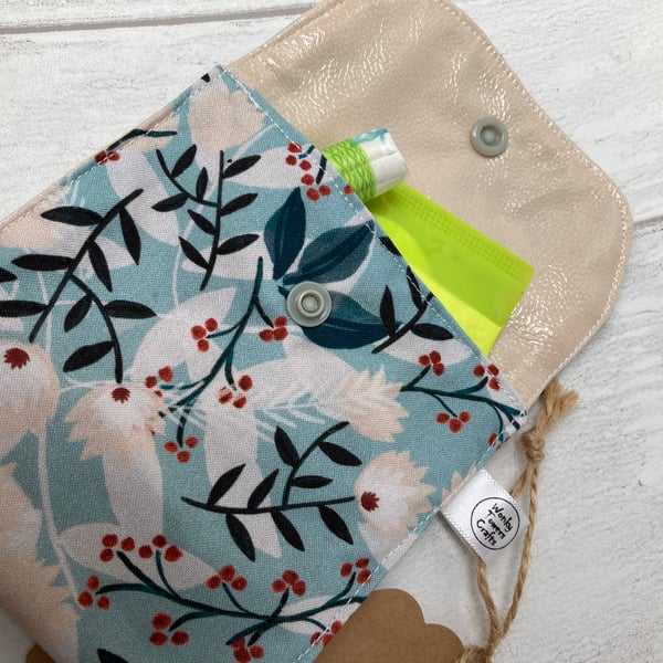 Sanitary product holder for handbag.