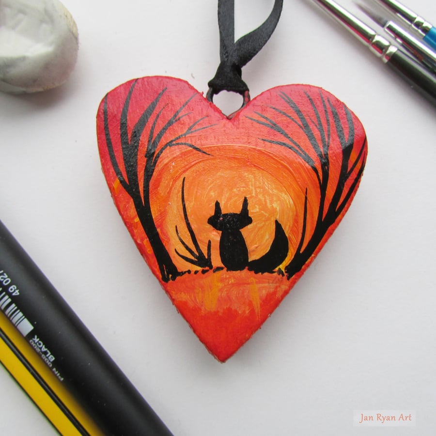 Fox silhouette by sunrise, yellow orange hanging heart