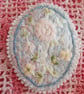 Oval, textile brooch with pastel, embroidered flowers. - Image 1