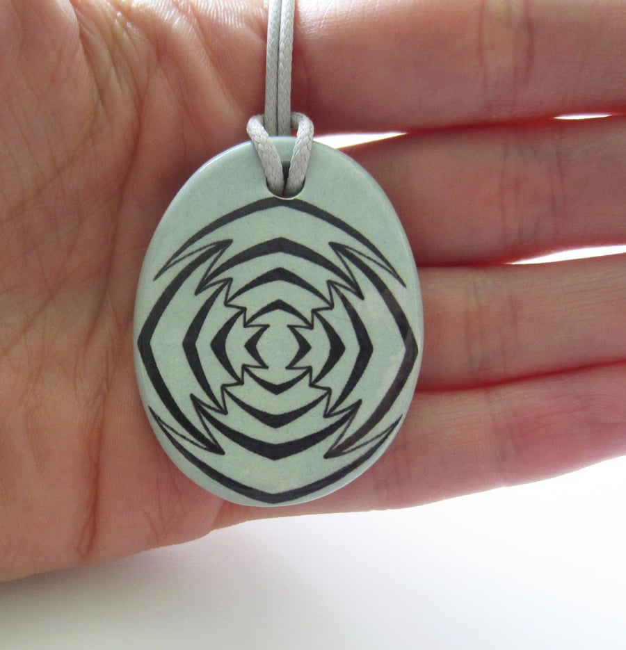 Jagged Target Design Oval Ceramic Pendant on Grey Cord with Lobster Clasp