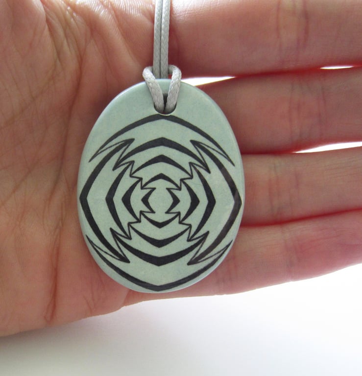 Jagged Target Design Oval Ceramic Pendant on Grey Cord with Lobster Clasp