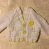 Hand Knitted Baby girls cardigan in a white yarn with yellow trim 0-3 months 