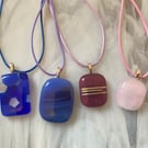 Four handmade fused glass pendants in pinks and purples