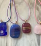 Four handmade fused glass pendants in pinks and purples