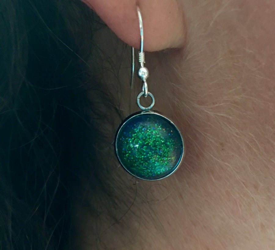 Aurora glow in the dark dangly earrings.