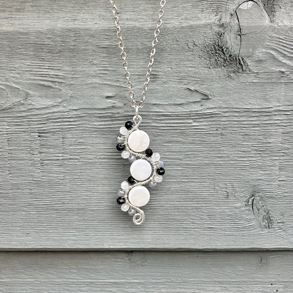 Curvy design beaded pendant necklace featuring shell beads