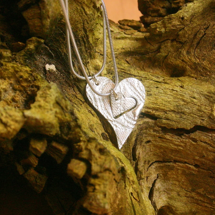 Two fine silver patterned heart pendants on sterling silver snake chains