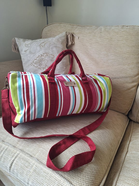 Striped holdall with shoulder strap.