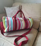 Striped holdall with shoulder strap.
