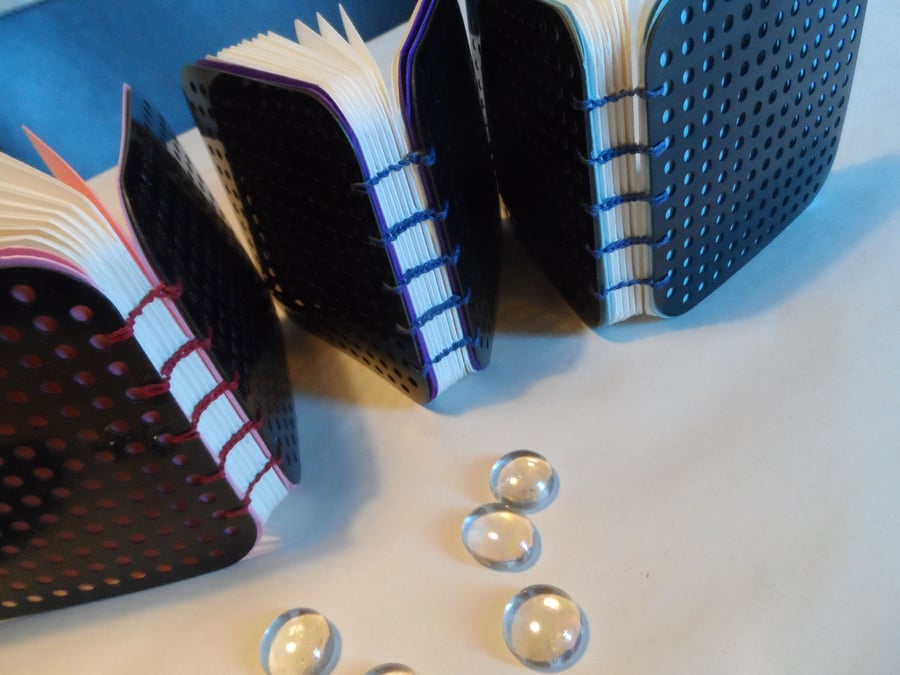 Three handstitched books with recycled covers  (no. 42) 