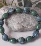 Handmade polymer clay bracelet in a forest green and ice blue mix