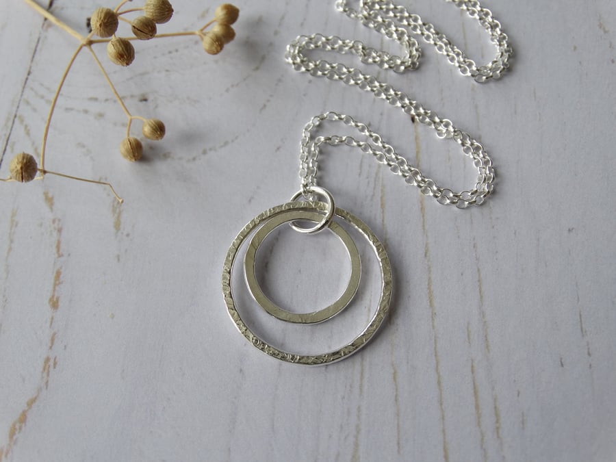 Textured double hoop pendant in recycled sterling silver on long chain