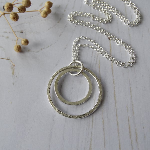 Textured double hoop pendant in recycled sterling silver on long chain