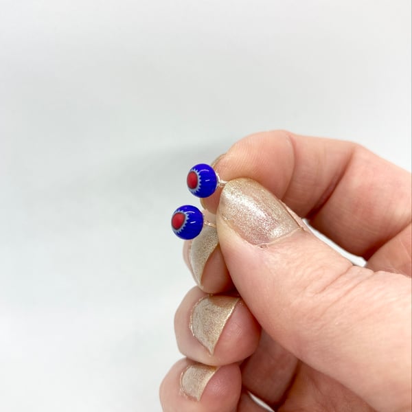 Royal blue glass earrings with red star burst pattern, sterling silver studs