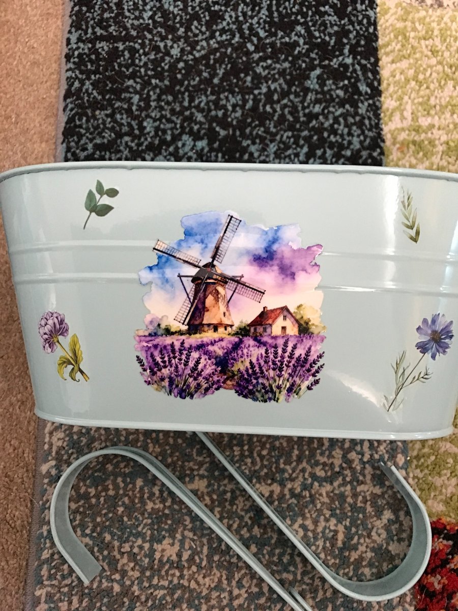 Pale blue fence planter with windmill motif 