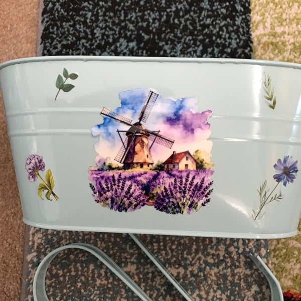 Pale blue fence planter with windmill motif 