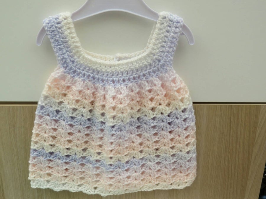 Pale pink, lilac and white lacy baby girl's crocheted summer dress