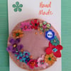 Pink flowery wreath brooch