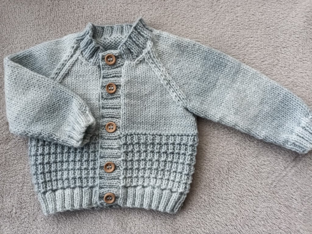 Newborn baby boys cardigan hand-knitted in a  soft mixed greyish blue baby yarn 