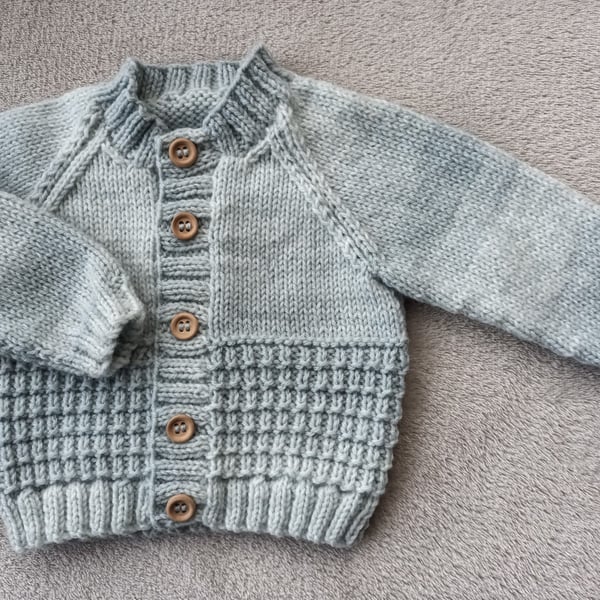 Newborn baby boys cardigan hand-knitted in a  soft mixed greyish blue baby yarn 