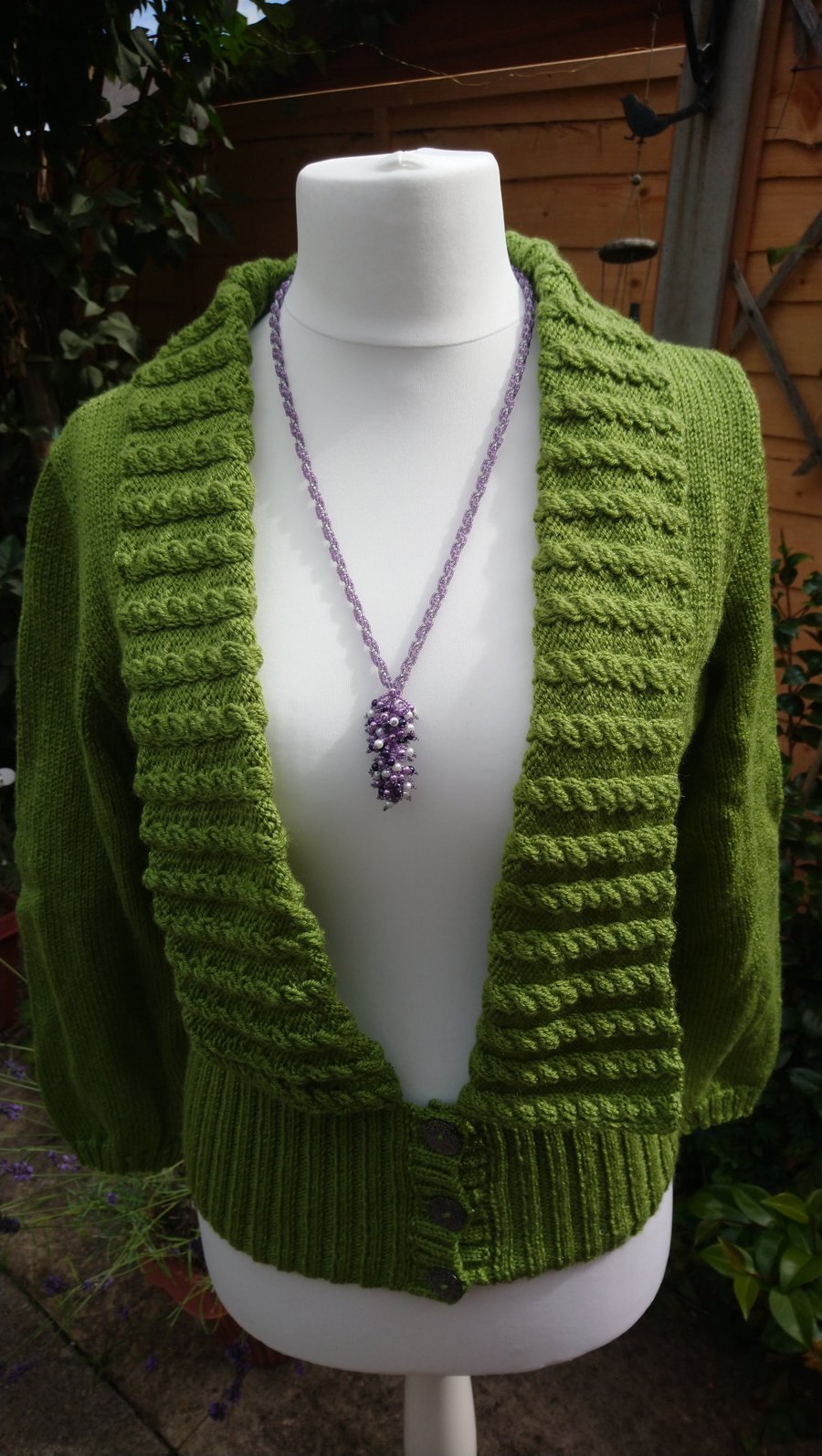 Hand knitted ladies cardigan with cable stitch collar