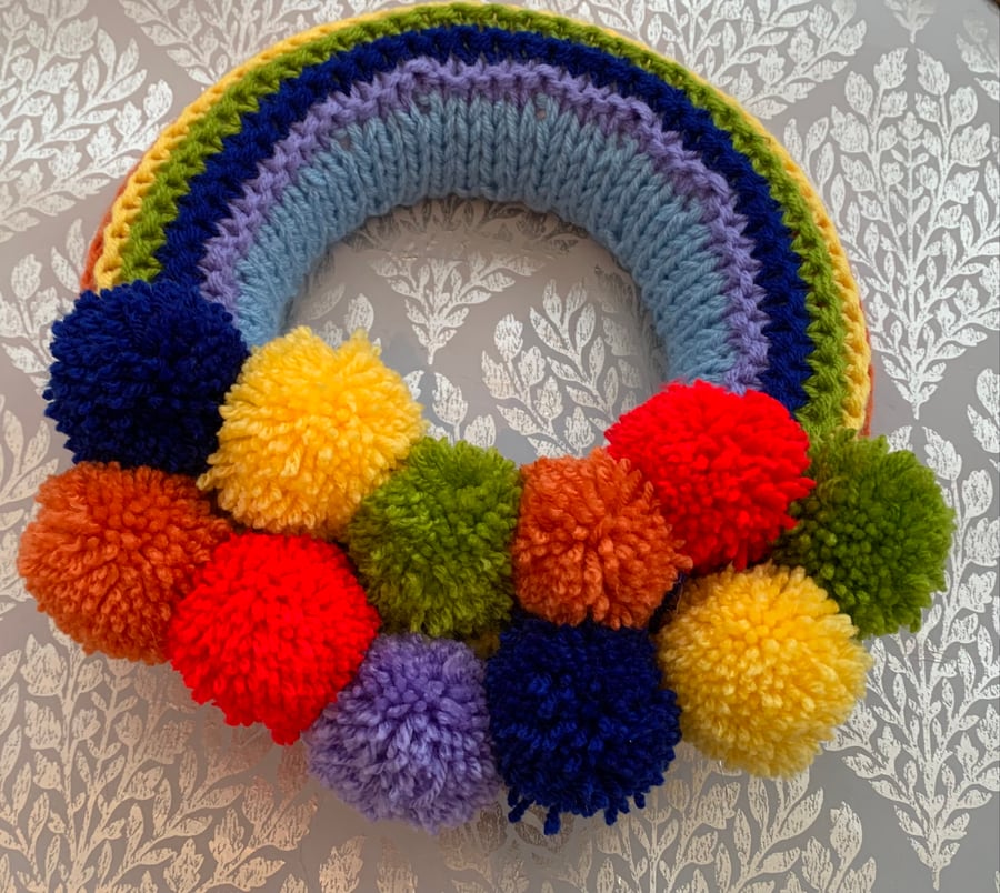 Knitted rainbow  wreath with pom poms 