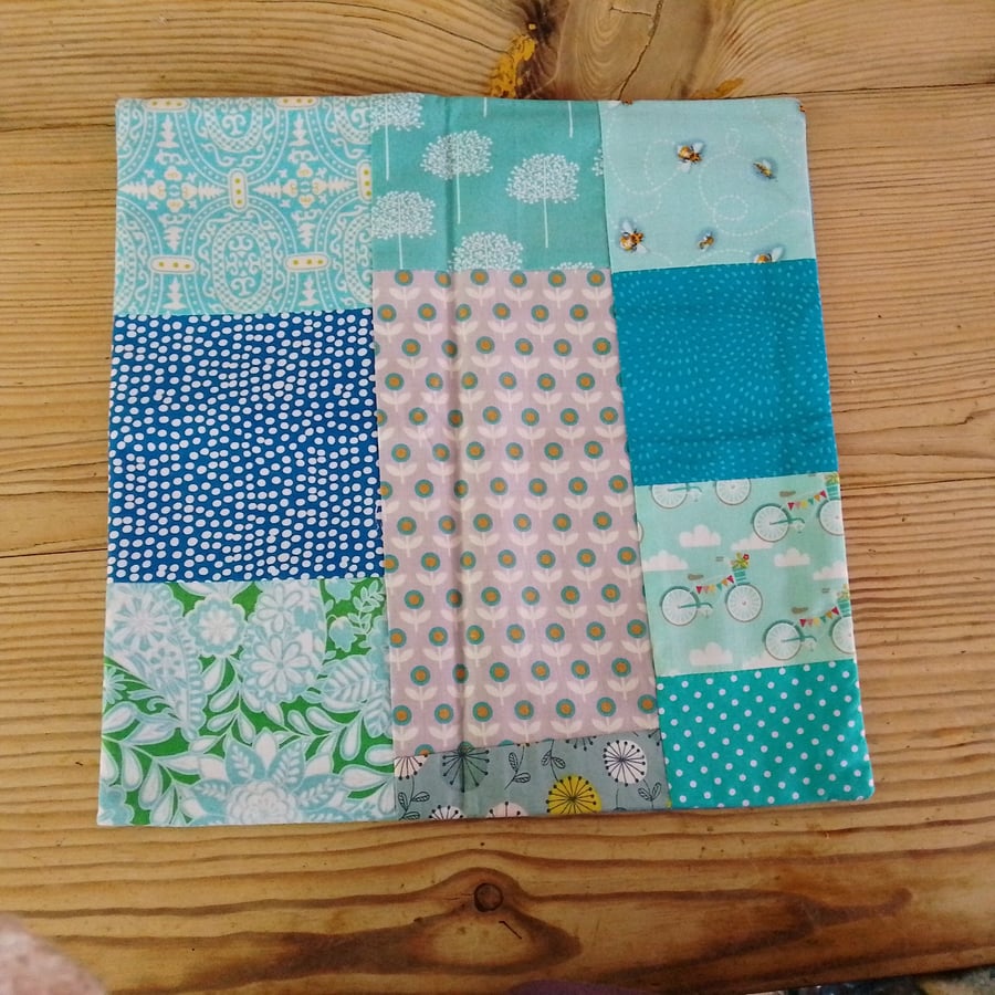 cushion cover handmade from a selection of blue fabrics with envelope closure.