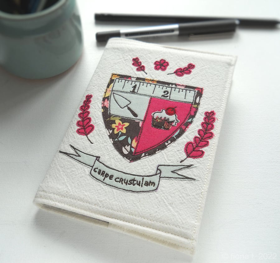 applique & freehand embroidered A6 notebook - cake coat of arms